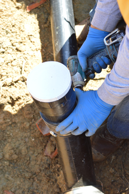 an Oakland sewer repair specialist is checking a newly installed sewer pipe
